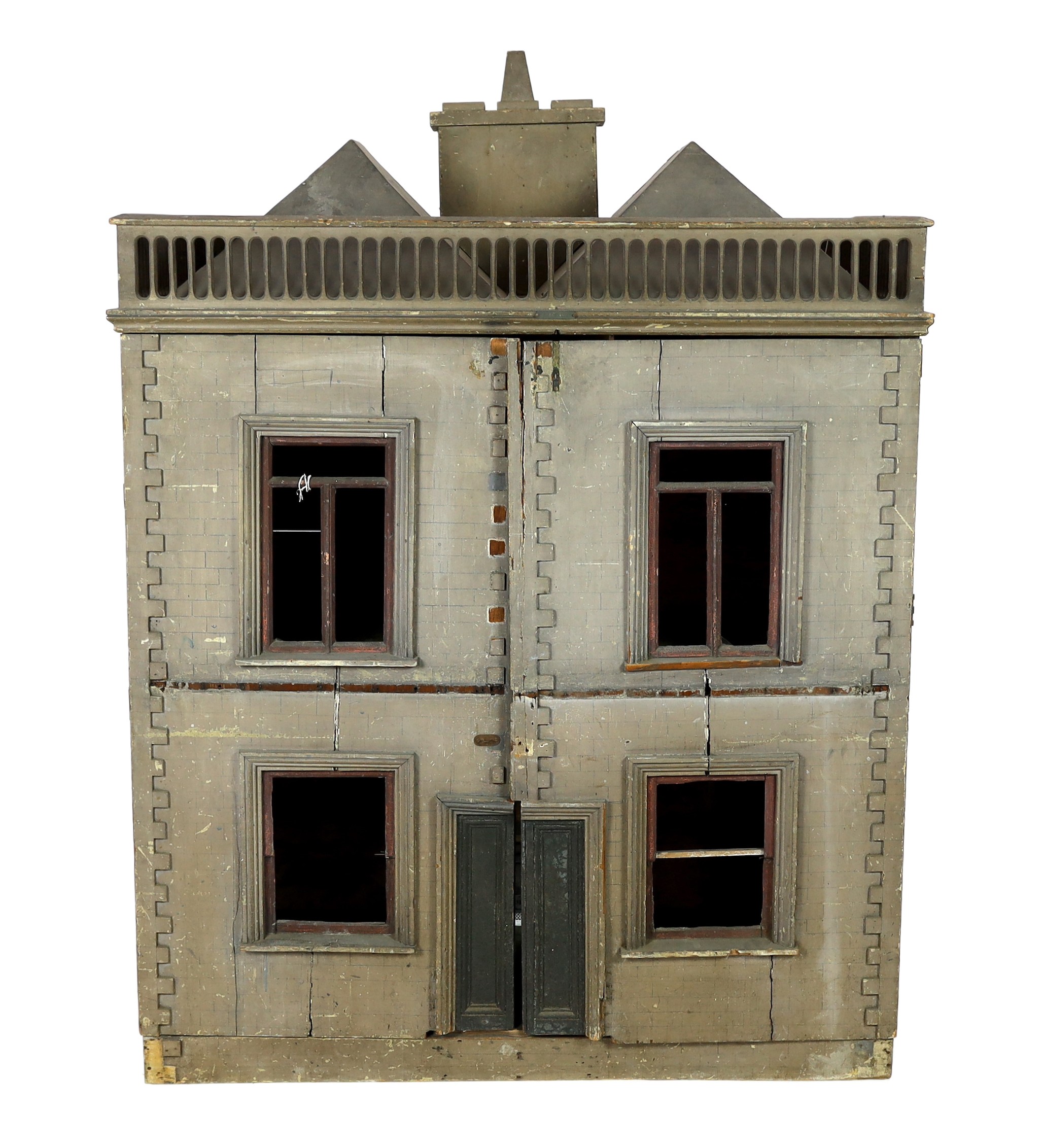 A very large English dolls’ house, circa 1840-1850, with a central panelled door and large windows