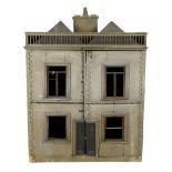 A very large English dolls’ house, circa 1840-1850, with a central panelled door and large windows