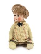A bisque doll, German, circa 1914, impressed 2, with open mouth and upper teeth, weighted blue glass
