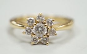 A modern yellow metal and diamond set flower head cluster ring, size L, gross weight 2.9 grams.