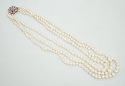 A 1960's triple strand graduated cultured pearl necklace, with 9ct white gold, ruby and diamond chip