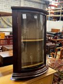 A reproduction George III style glazed mahogany bowfront hanging corner cupboard, width 49cm,