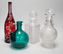 A green glass decanter flagon, a Bohemian red flash cut carafe (lacking stopper), a pineapple cut