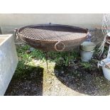 A large circular wrought and cast iron fire pit on stand diameter 133cm height 81cm