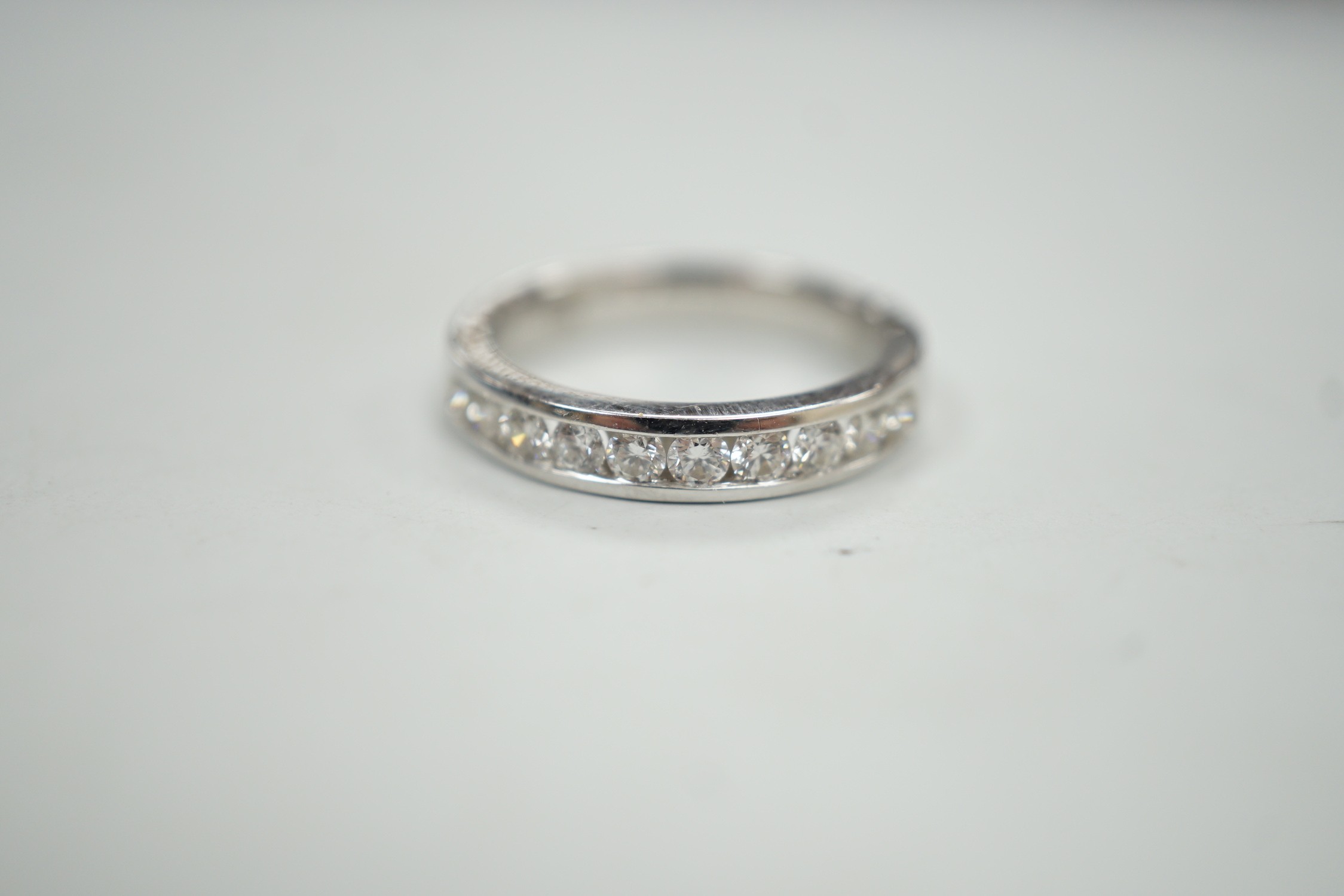 A modern 18k white metal and ten stone channel set diamond half eternity ring, size L/M, gross - Image 2 of 5
