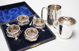 A late Victorian engraved silver christening cup, a later silver christening cup and a cased set