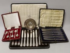 A cased set of six silver coffee spoons, a cased set of six silver-handled dessert knives, a small