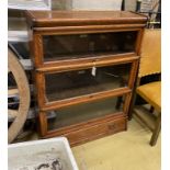 A Globe Wernicke oak three section bookcase with base drawer, width 86cm, depth 27cm, height 114cm