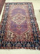 A Mallayar red ground rug, 205 x 128cm