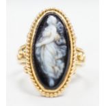 An early 20th century yellow metal and black sardonyx set cameo ring, carved with the figure of a