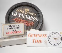 A Guinness time illuminating timepiece, Guinness display light and a Guinness advertising barrel