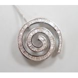 A modern 750 white metal and baguette cut diamond set whorl design pendant, 22mm, gross 4.5 grams,