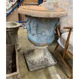 A reconstituted stone campana garden urn on a later composite base, diameter 58cm, height 76cm