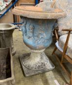 A reconstituted stone campana garden urn on a later composite base, diameter 58cm, height 76cm