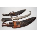 Two Kukri and eastern daggers, within engraved sheath, (3)