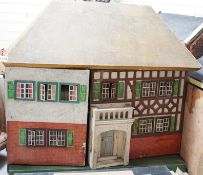 A Tri-ang dolls’ house, mid 20th century, with a rough cast facade, a section of half-timbering