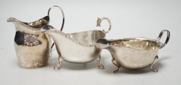 A George III silver cream jug, London, 1801, height 11cm, together with two later silver sauceboats,
