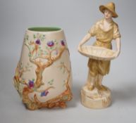 A Royal Dux figure of a water carrier and a Clarice Cliff for Newport Pottery vase. Tallest 27cm