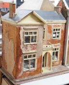An English back-opening furnished dolls’ house, c.1900, modelled as a double-fronted brick villa,