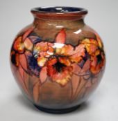 A Moorcroft flambé ‘orchid’ globe shaped vase, 21cm