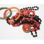 A spinach green Jade bangle and hardstone bead necklaces