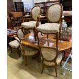 A Queen Anne Revival oval walnut extending dining table, length 162cm extended, one spare leaf,