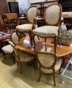 A Queen Anne Revival oval walnut extending dining table, length 162cm extended, one spare leaf,