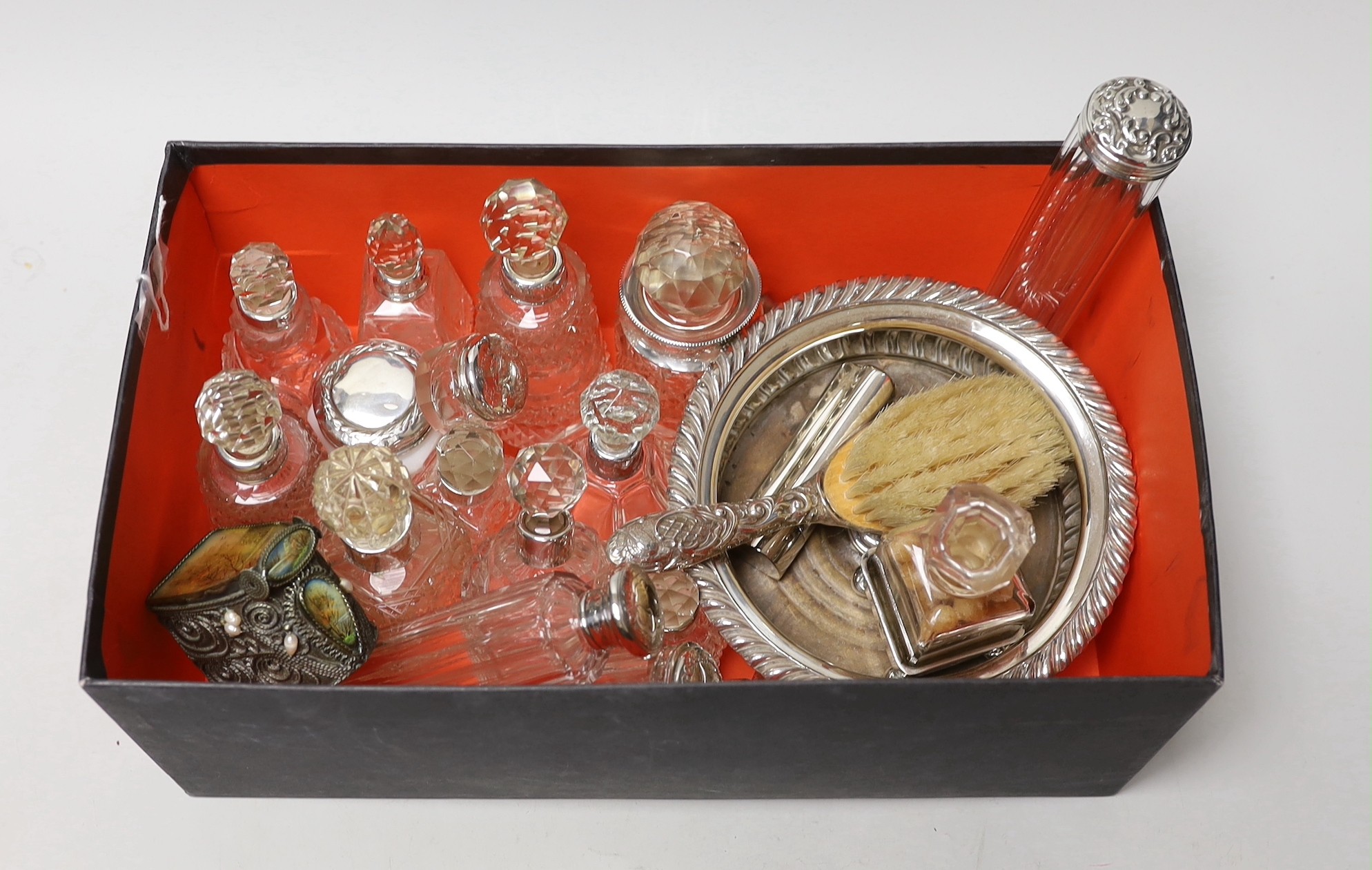 A collection of assorted silver mounted glass scent bottles and other items including a wine coaster