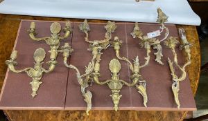 Eight assorted cast brass twin branch wall lights, largest height 37cm