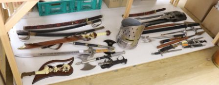 A group of reproduction swords and weapons