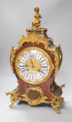 A French scarlet Boulle work and ormolu mounted mantel clock with enamel dial, 45cms high
