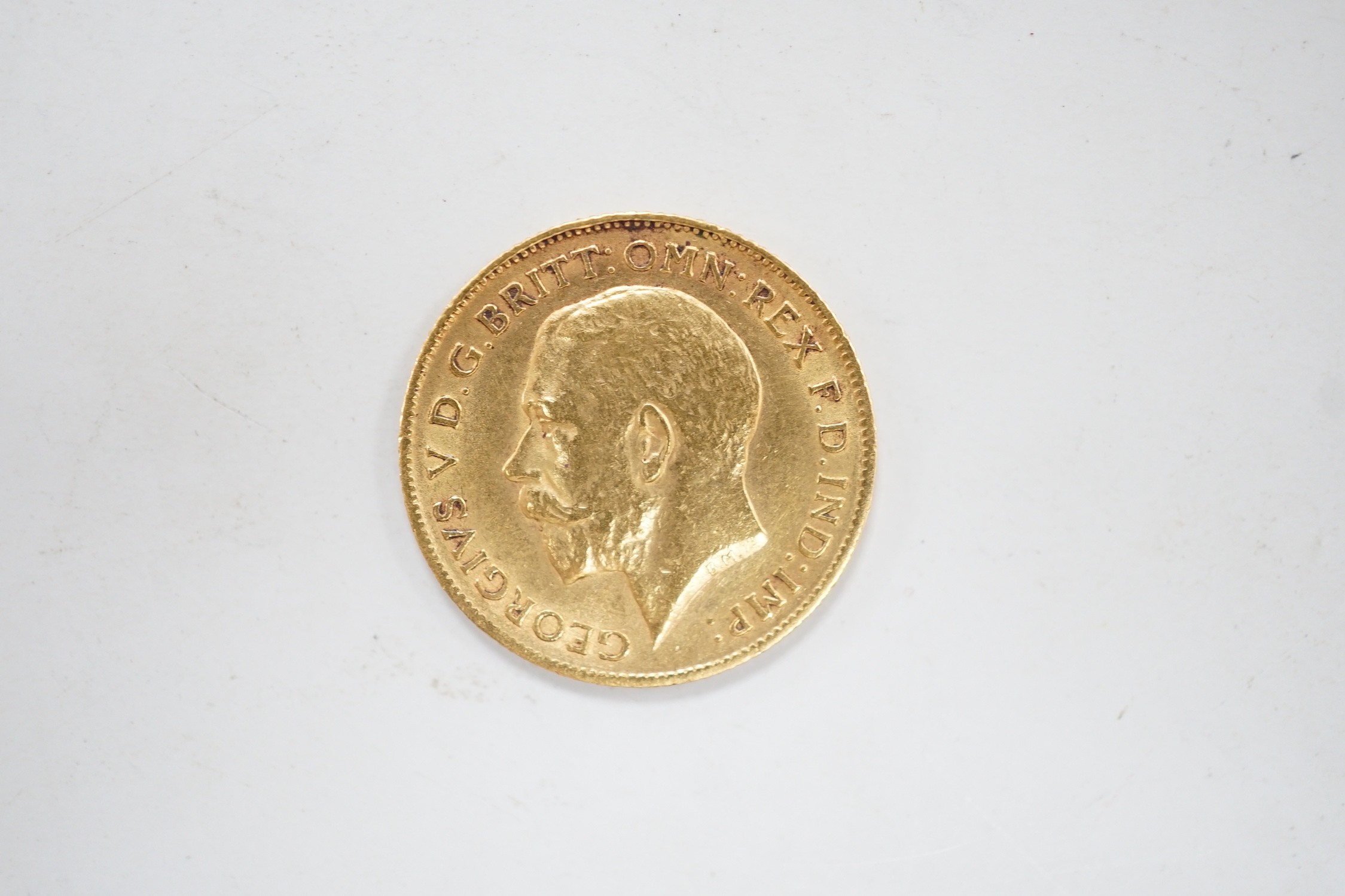 A George V 1911 gold half sovereign, with leather purse. - Image 2 of 2