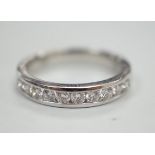 A modern 18k white metal and ten stone channel set diamond half eternity ring, size L/M, gross