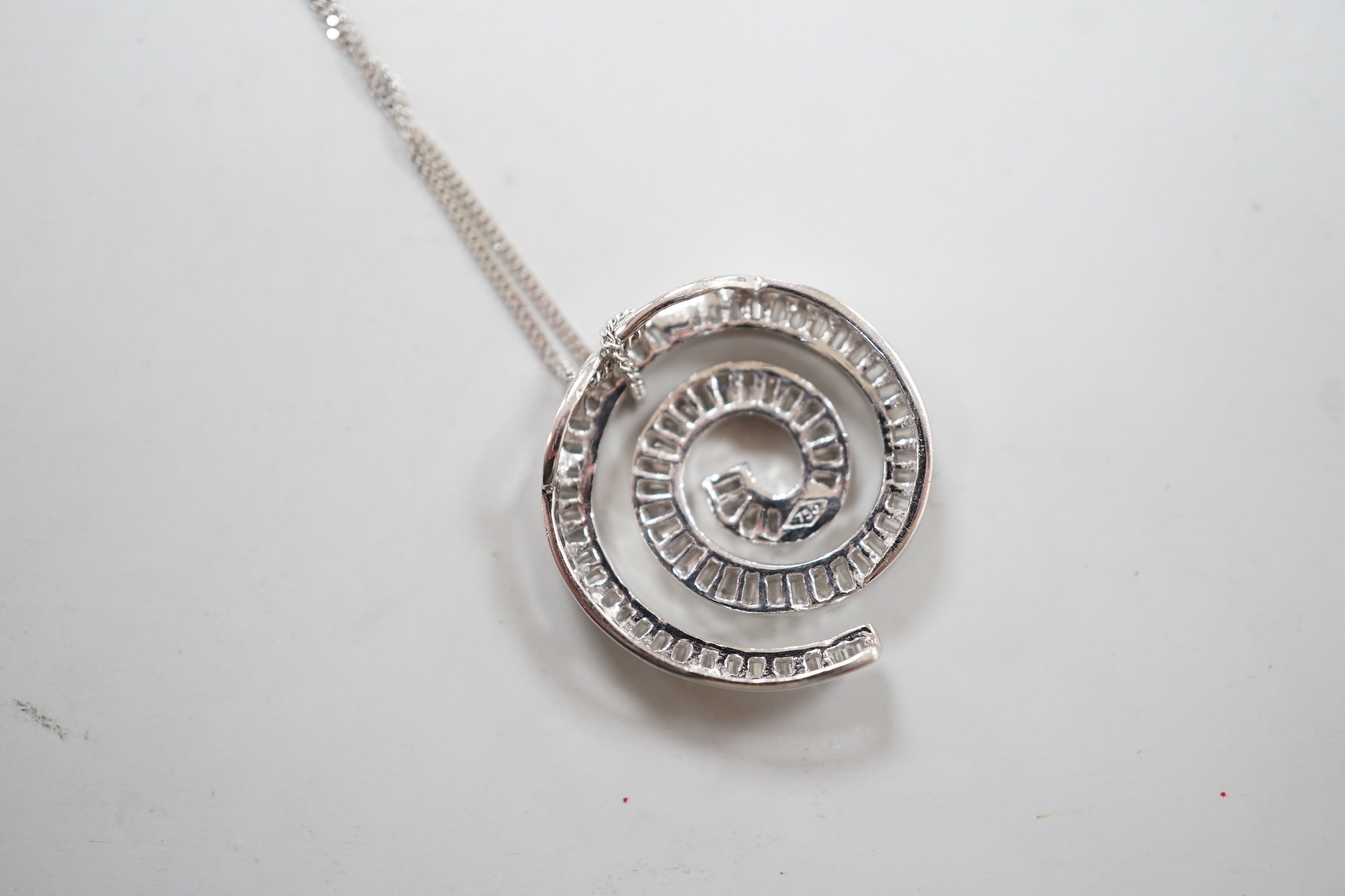 A modern 750 white metal and baguette cut diamond set whorl design pendant, 22mm, gross 4.5 grams, - Image 3 of 3