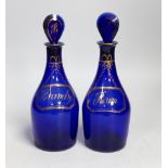 A pair of George III Bristol blue glass and gilt decanters, ‘Brandy’ and ‘Rum’. 23cm tall