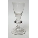 A George I heavy baluster wine glass, round funnel bowl above angular knop with air-tear, circa