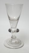 A George I heavy baluster wine glass, round funnel bowl above angular knop with air-tear, circa