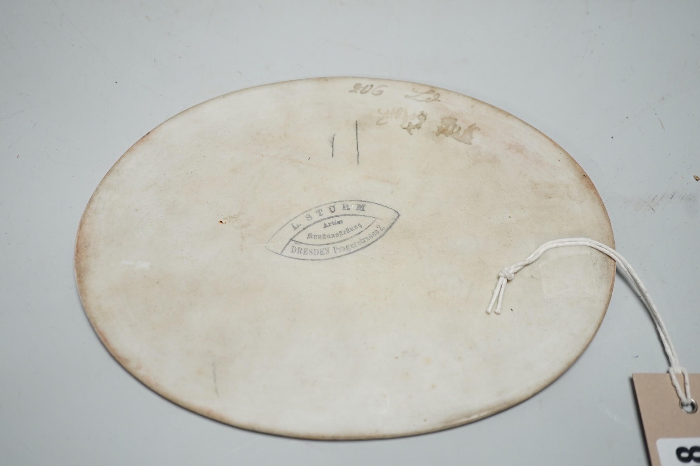 A 19th century painted porcelain oval plaque of a reclining lady reading a book. The reverse stamped - Image 4 of 4