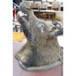 A mounted taxidermic boar's head wall trophy on wood back plate, height 64cm