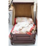 An Armand Marseille 390 A 11/2 M porcelain doll and a half tester wooded bed, bed 55cms deep x 55cms
