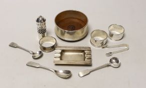 A silver coaster, ashtray, two napkin rings, cutlery etc.