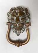 A large bronze lion mask door knocker. 20cm tall overall