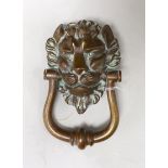 A large bronze lion mask door knocker. 20cm tall overall