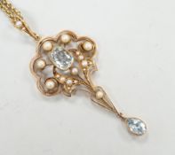 An Edwardian 15ct, aquamarine and seed pearl set drop pendant, 56mm, gross weight 5.3 grams, on a