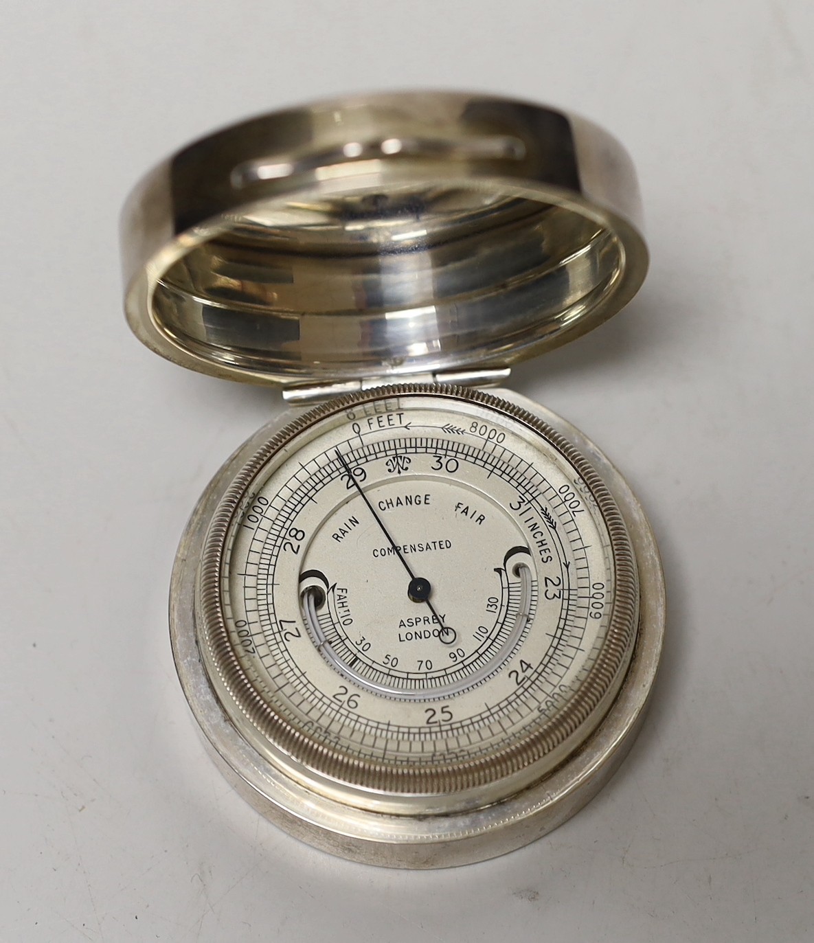 A George V Asprey & Co silver cased barometer, London, 1922, diameter 56mm.