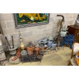 A large quantity of assorted garden ornaments, terracotta pots, galvanised watering cans, bench