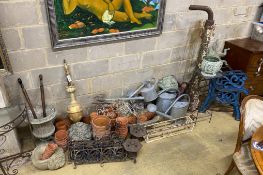 A large quantity of assorted garden ornaments, terracotta pots, galvanised watering cans, bench