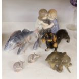 A Royal Copenhagen figure group of two children hugging a puppy, two other dog ornaments, three fish