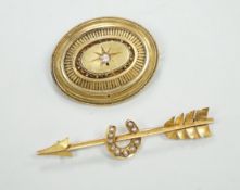 An early 20th century yellow metal, and seed pearl set arrow and horse shoe brooch, 60mm and a