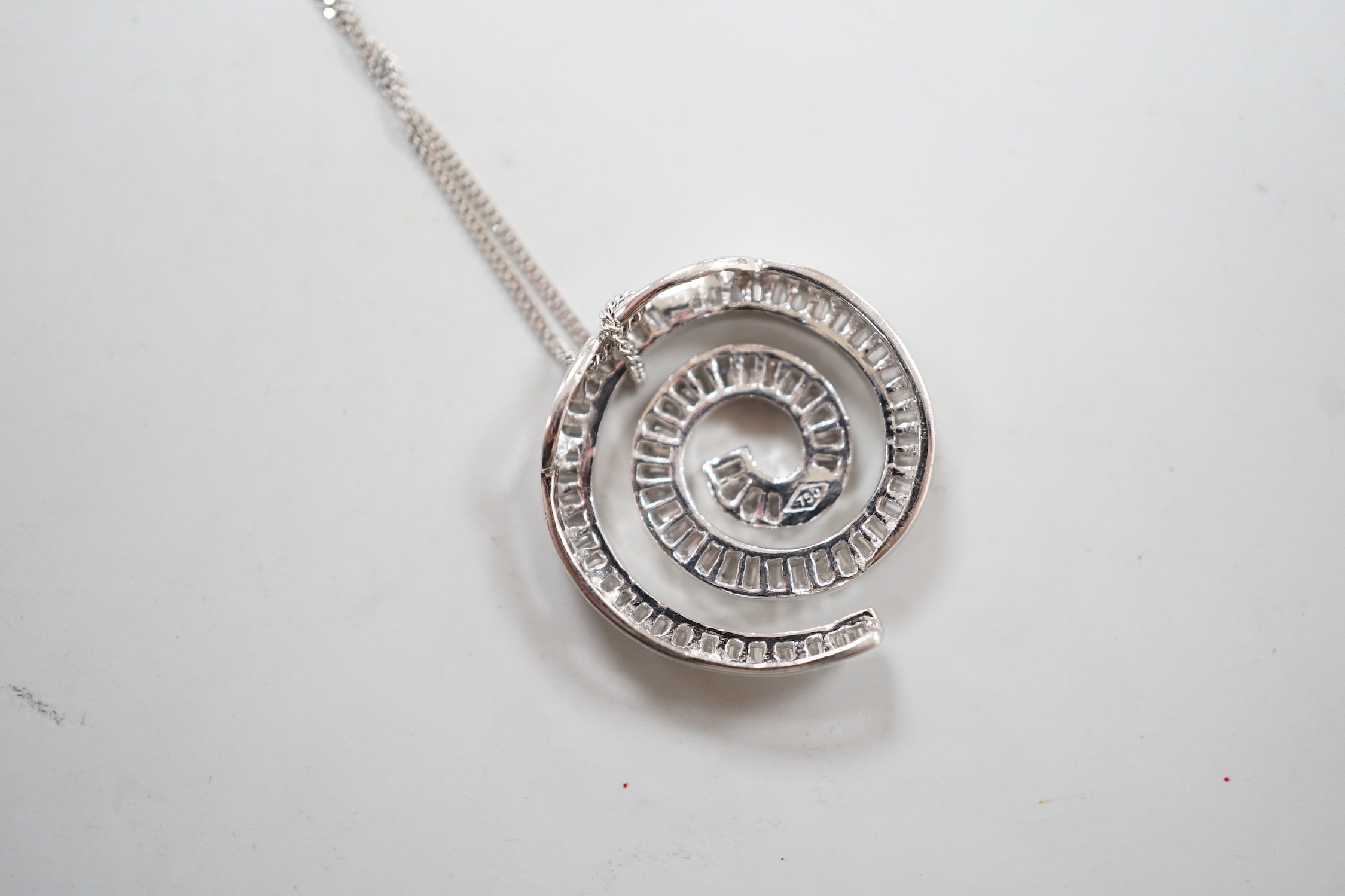 A modern 750 white metal and baguette cut diamond set whorl design pendant, 22mm, gross 4.5 grams, - Image 2 of 3